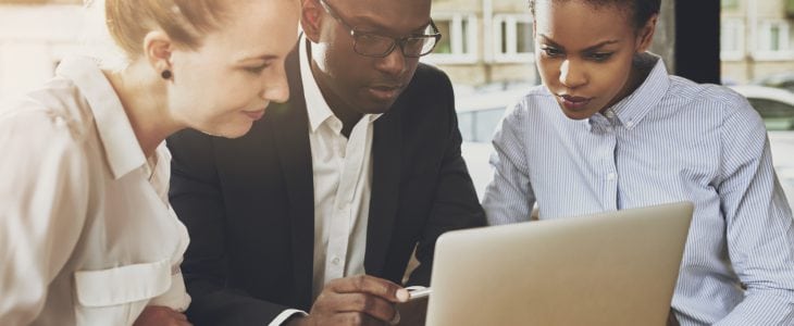 Black and white business people working together at small office